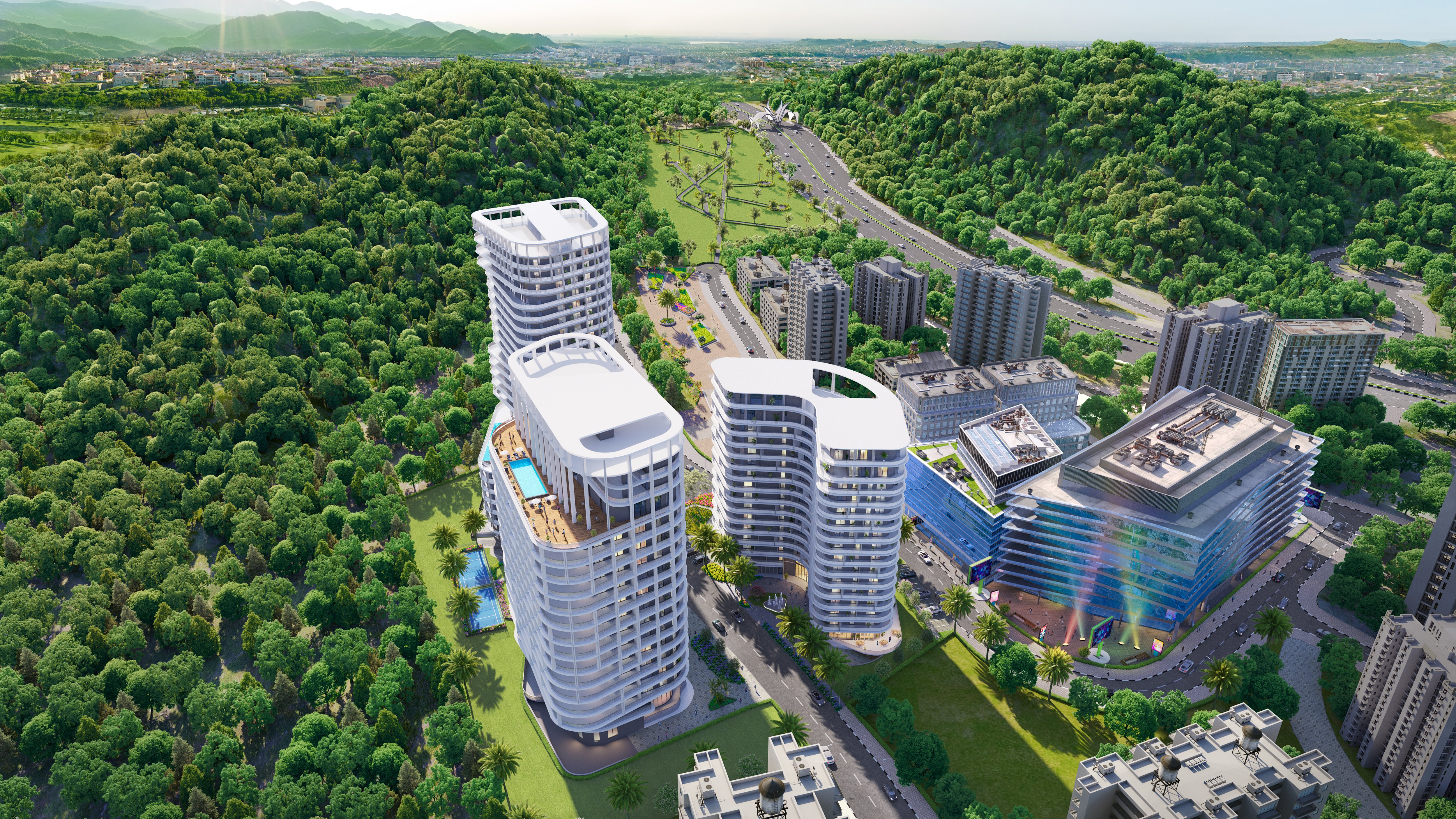 Aerial view of modern high-rise residential towers, surrounded by lush greenery and scenic hills.