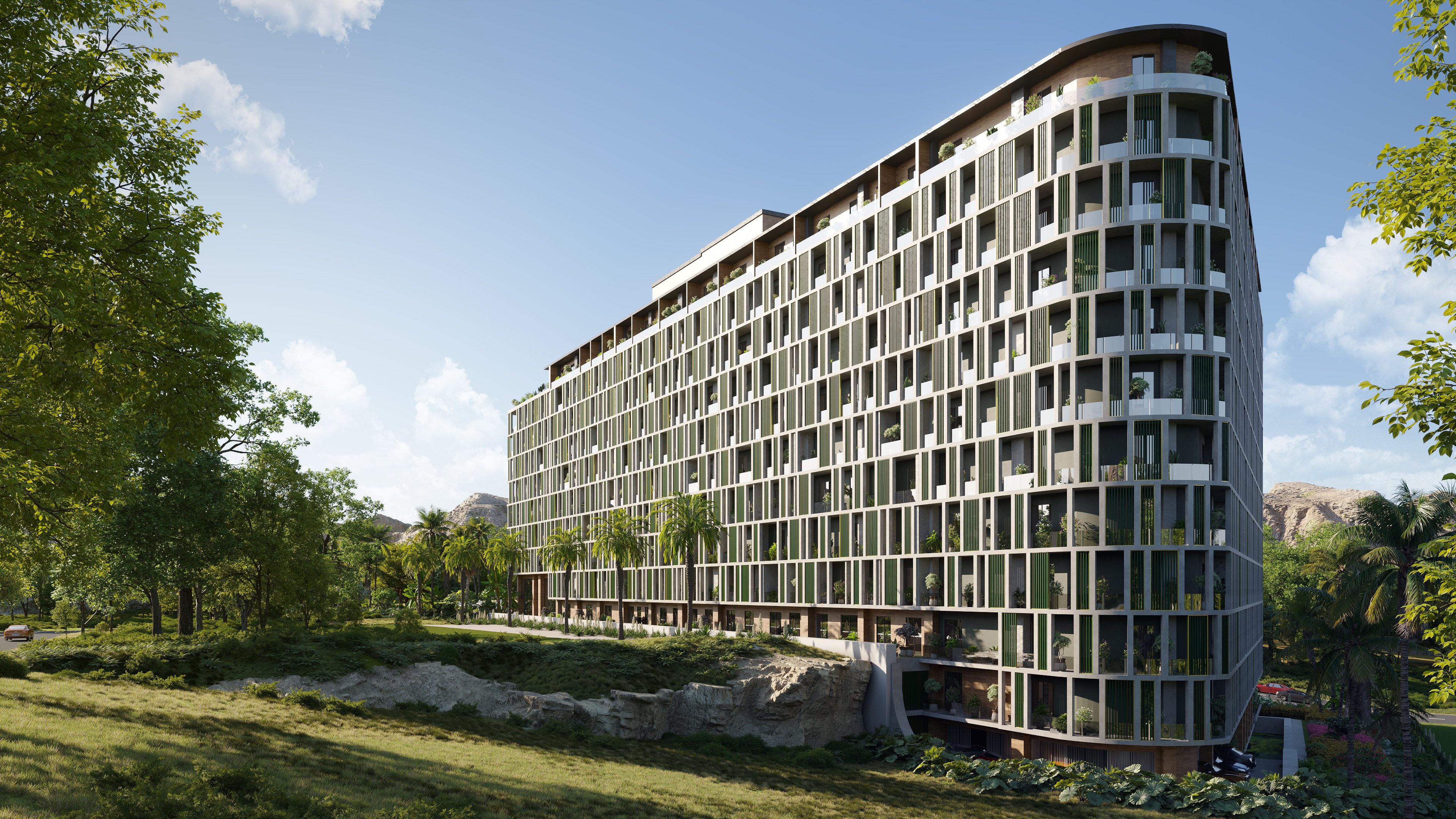 A modern apartment building amidst rocks, plains, and lush foliage