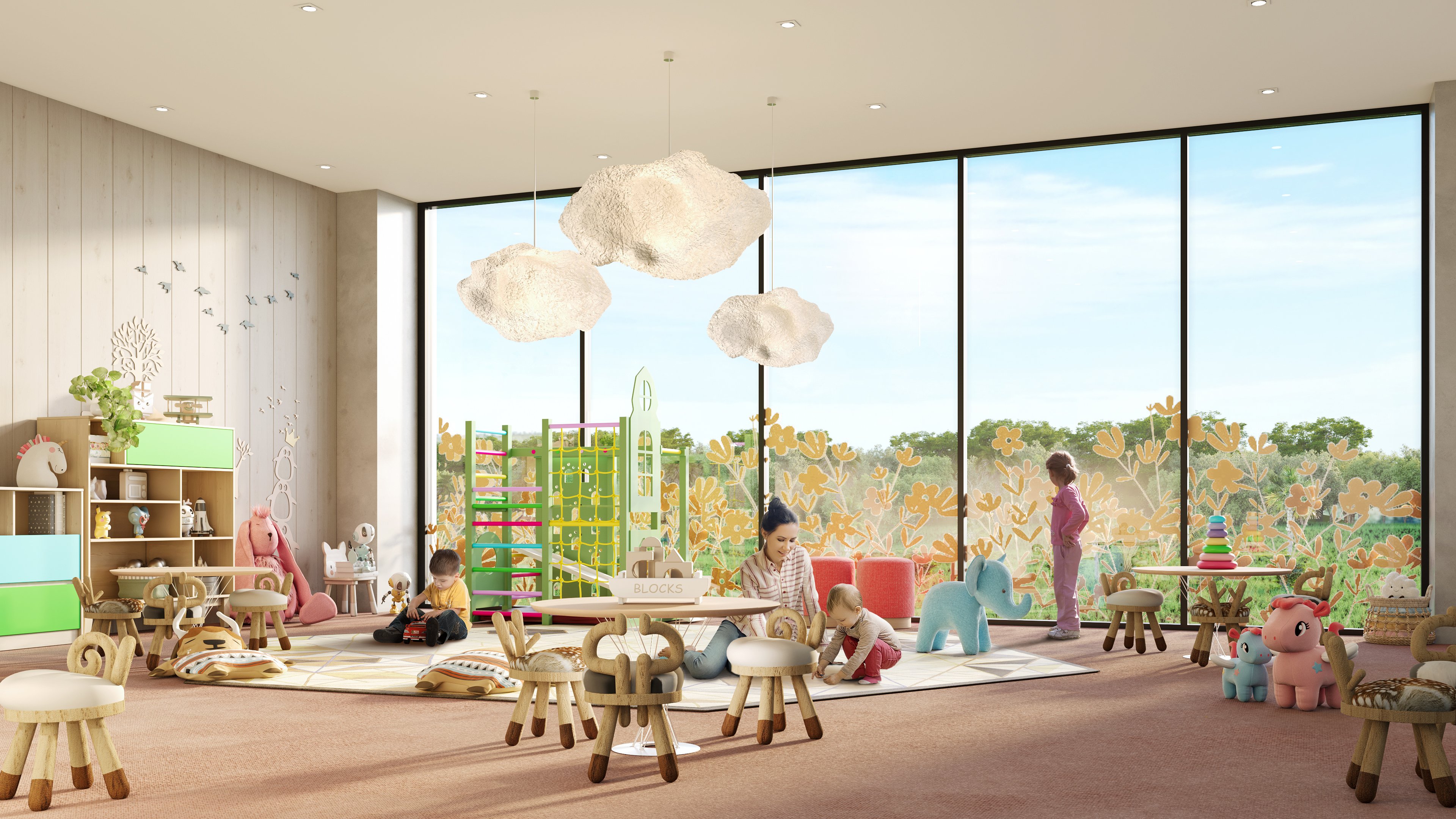  A large room with a pink carpet, children's furniture and toys has an adult sitting on the floor with a young toddler, while another child stands by a large window,w and one sits on the side