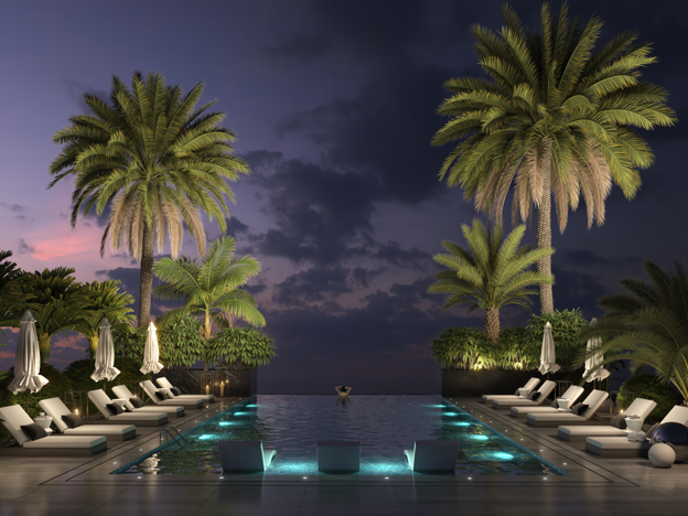 An infinity pool on the rooftop with palm trees on either side and pool chairs on the deck with a dusky evening sky in the distance