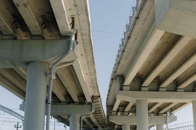 Two structures of a flyover supported by pillars are seen in a close-up photo from below