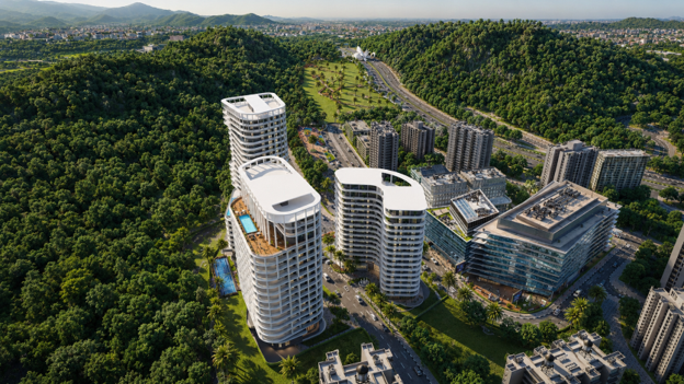 Aerial view of a luxury One Homes mixed-use residential development surrounded by lush green hills in Islamabad, showcasing premium apartments and commercial spaces.