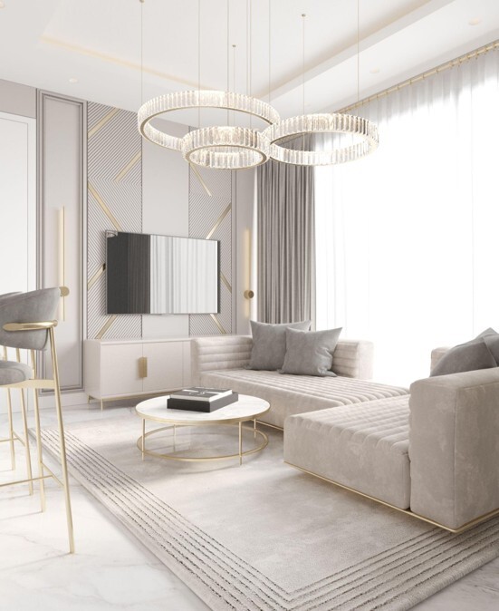 A tasteful lounge set up in light grey tones with a modern light fixture overhead