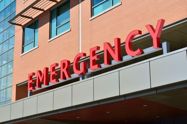 A large sign reading EMERGENCY on the outside of a building