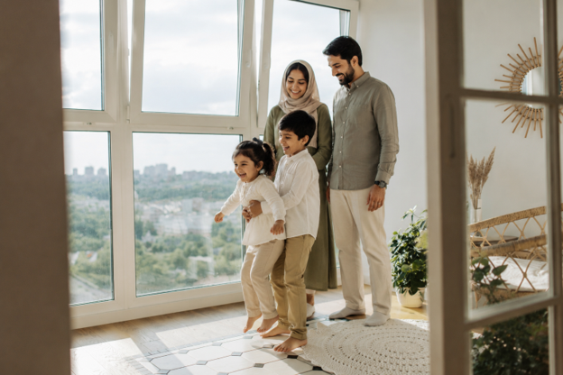 Pakistani family enjoying time together in a bright, modern home, reflecting the comfort, security and lifestyle that quality real estate investment in Pakistan can provide.