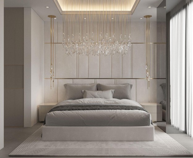 A bedroom in neutral shades of cool grey with hanging light fixtures in gold with crystals
