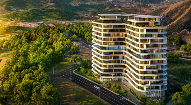 Luxury residential apartment tower surrounded by greenery and hills in Islamabad during golden hour