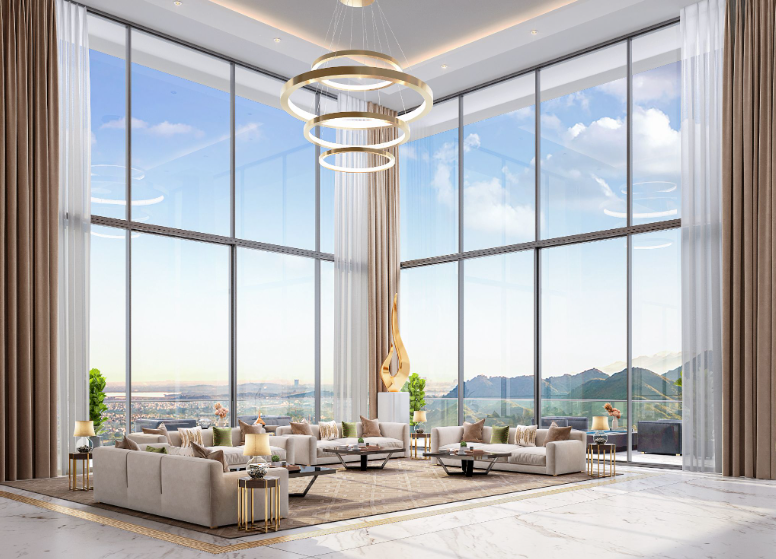 A sofa set on a large carpet in the middle of a large space with tall ceilings and full-length windows