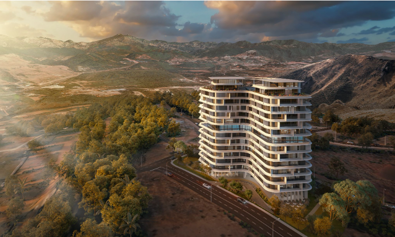 A luxury apartment building stands tall, surrounded by trees, roads, and hills