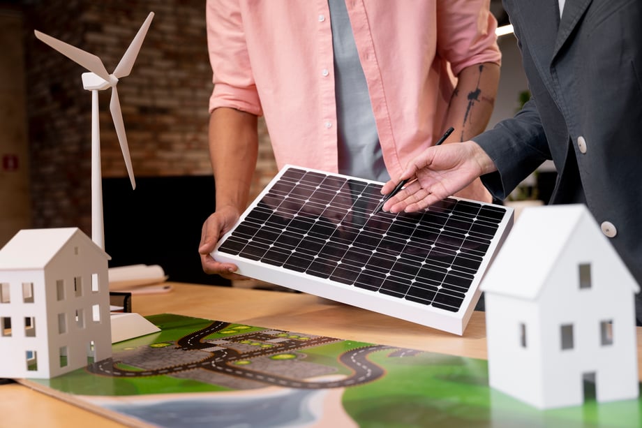 Business professional reviewing alternative energy plans, symbolising solar and smart systems in sustainable real estate