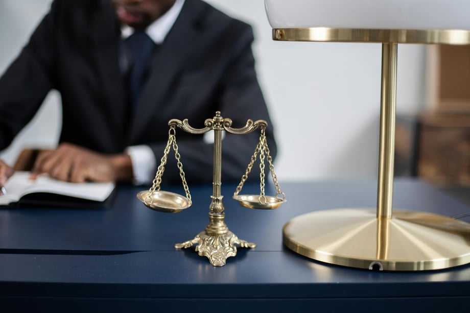Professional lawyer reviewing legal paperwork and property documents at an office desk