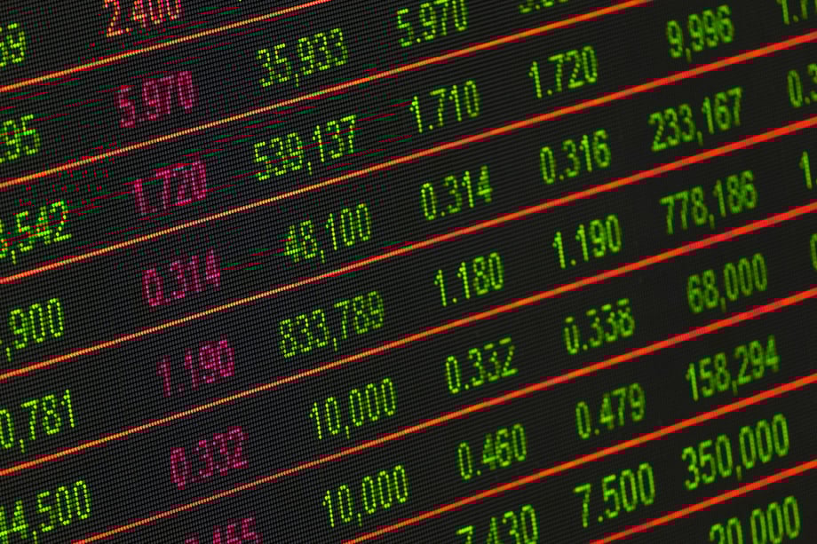 Digital stock exchange board displaying market numbers and financial data.
