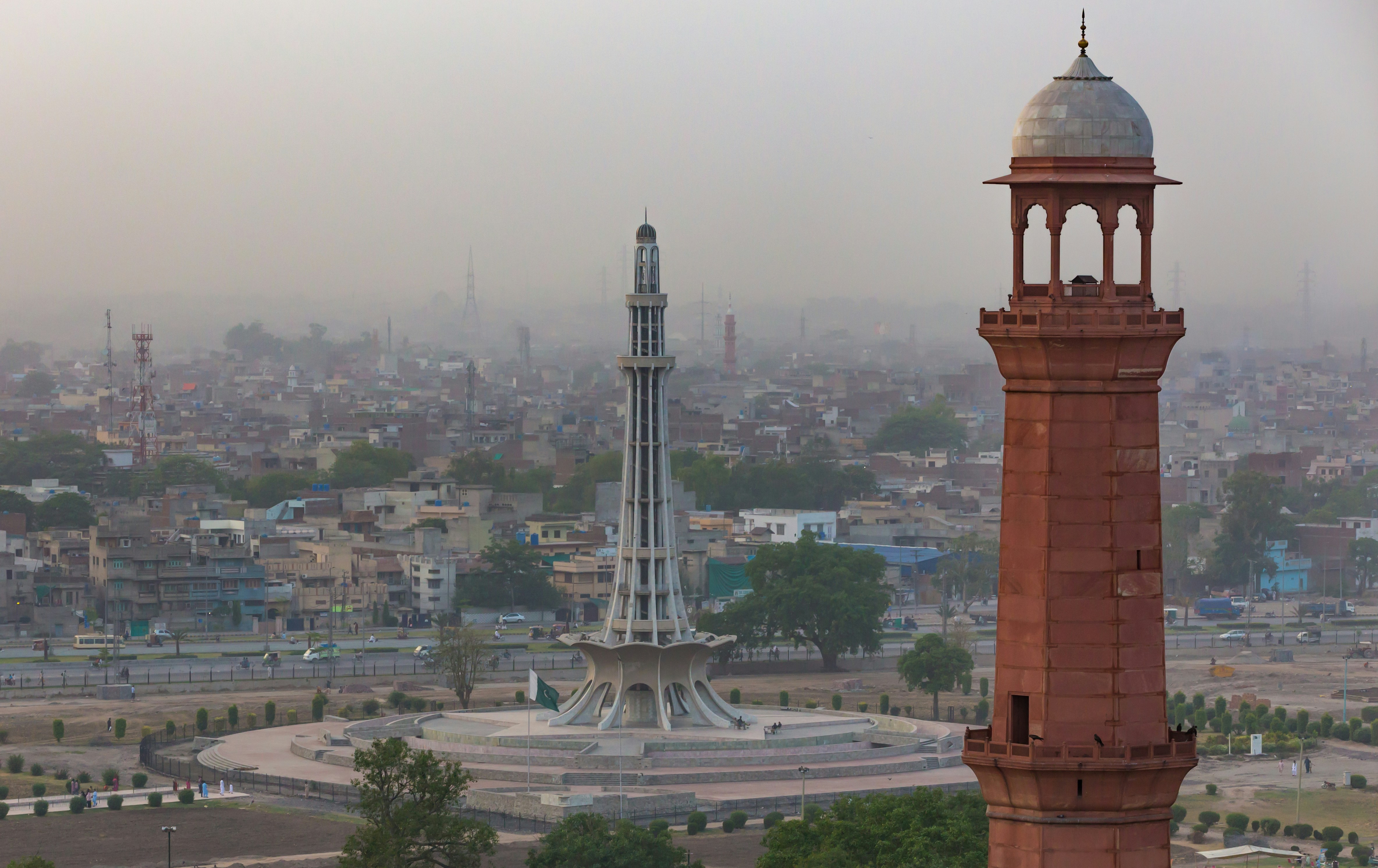 Minar-e-Pakistan stands tall with a minaret in the foreground